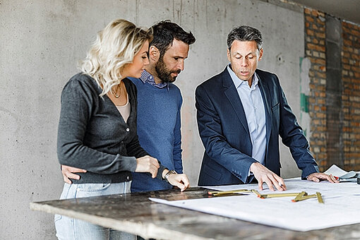 two men and one women are talking about plans, trusted partner